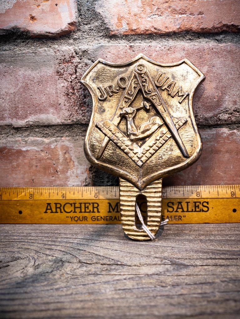 This Freemason-style plaque, embossed with the letters 'JR.O UAM